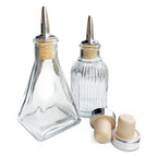 Two glass condiment bottles with wooden and metal caps on a white background