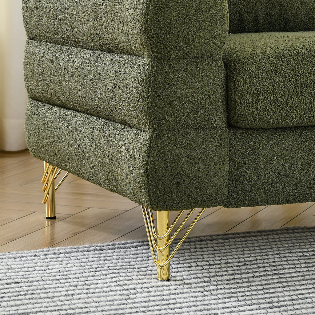 Green textured sofa with gold legs on a wooden floor.