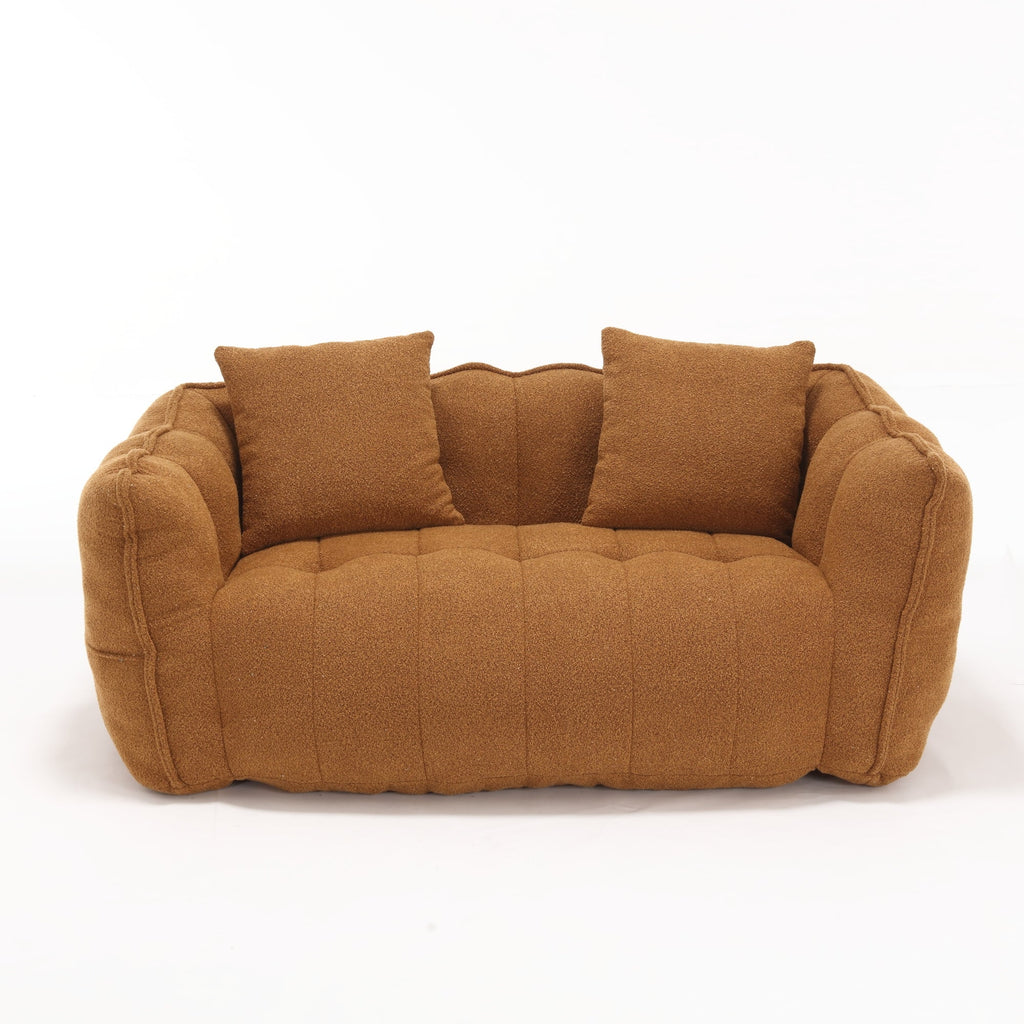 Brown sofa with two cushions on a white background