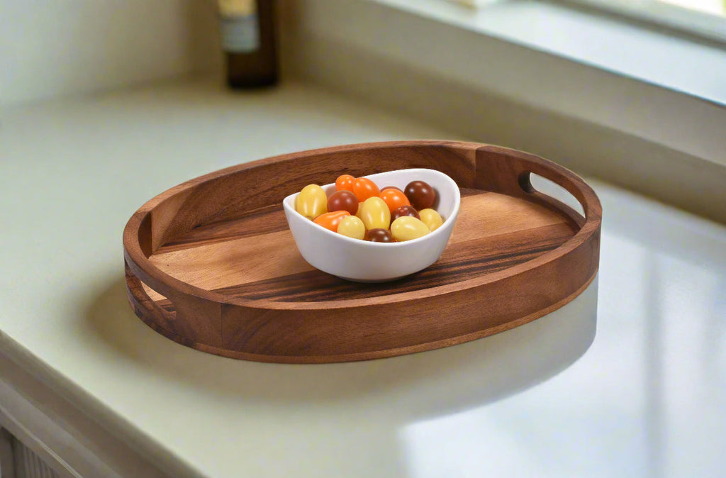Wooden tray with a bowl of fruit on a light-colored surface