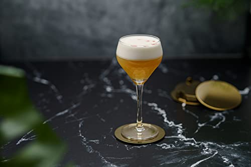 Cocktail in a glass on a dark marble surface with a blurred background