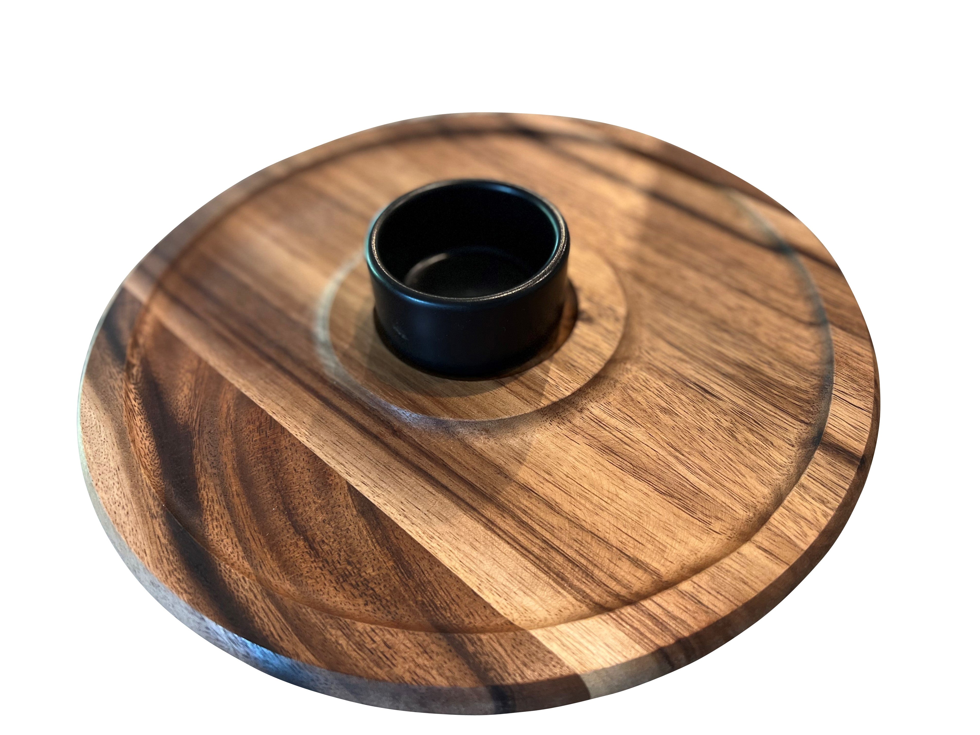 Wooden serving plate with a central bowl on a white background