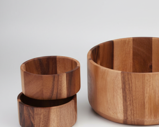 Set of wooden bowls and spoons on a white background
