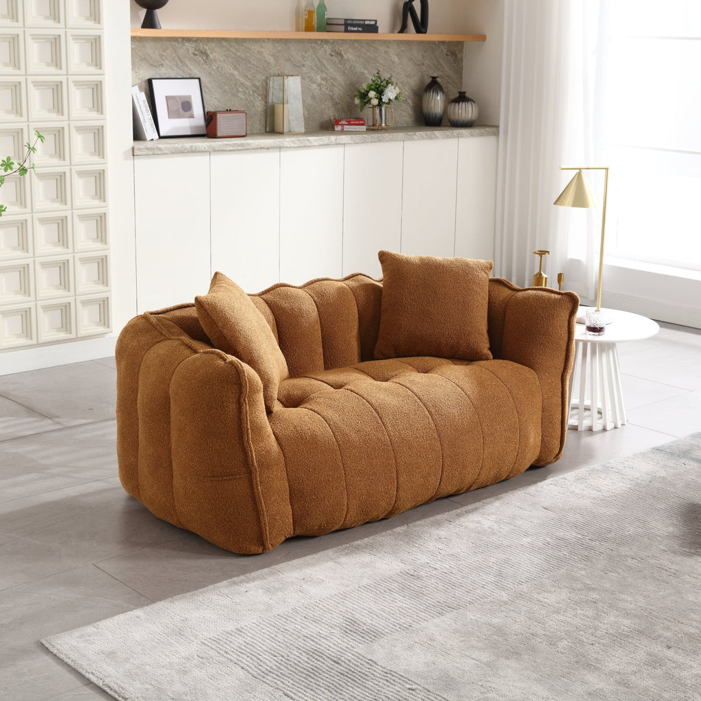 Brown sofa in a living room setting with a white wall and decorative items.