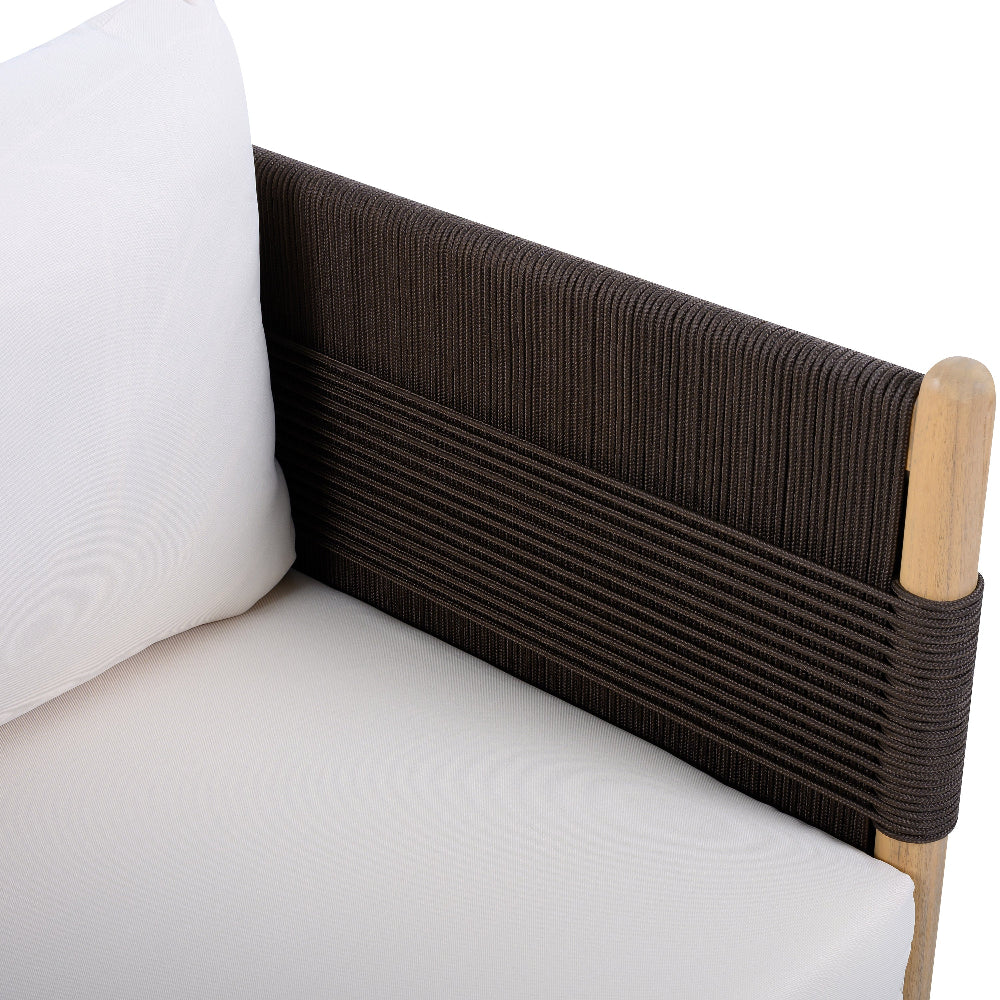 Section of a sofa with brown woven backrest and white cushion on a white background