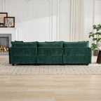 Green sofa in a living room setting with a fireplace and plants.