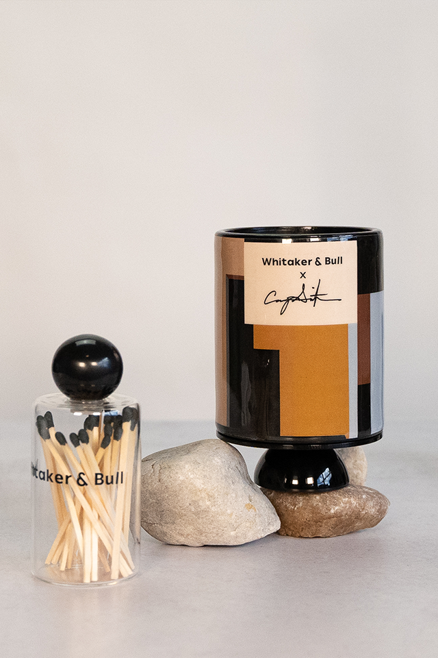 Candle and matchbox set with 'Whittaker & Bull' branding on a neutral background
