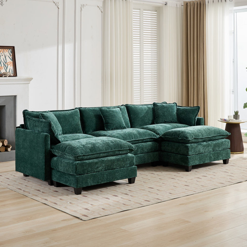 Green sectional sofa in a living room with light wood flooring and white walls.