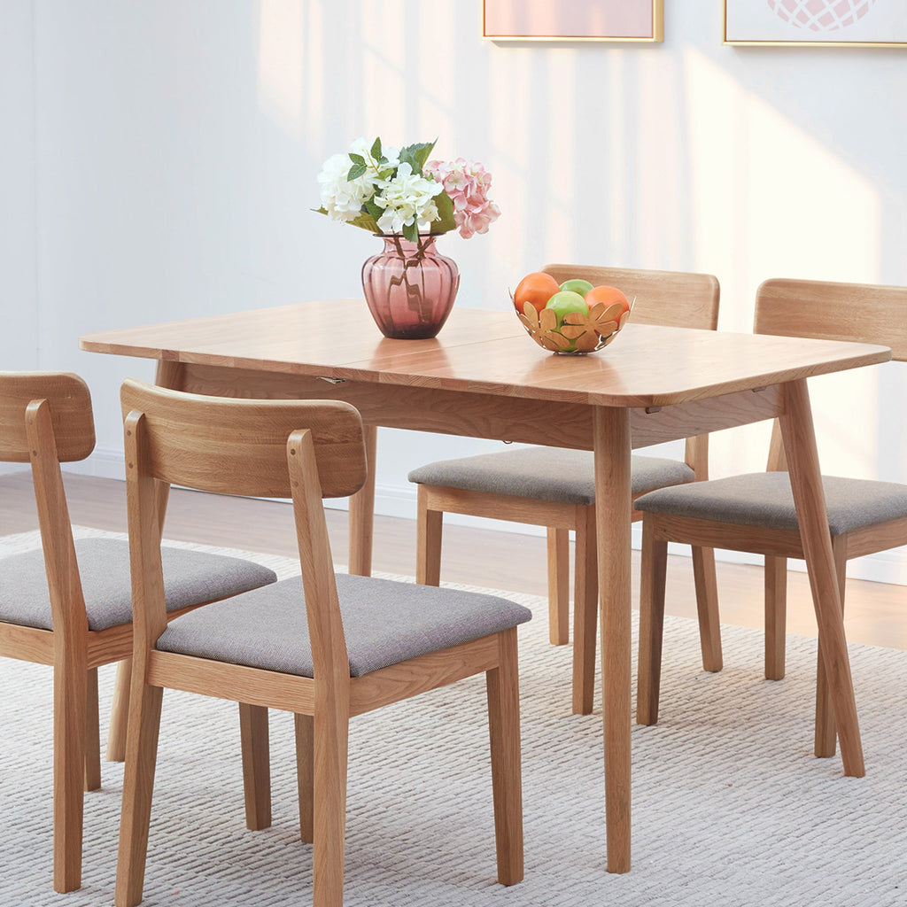 Dining table set with chairs and decorative items in a room.