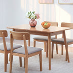 Dining table set with chairs and decorative items in a room.
