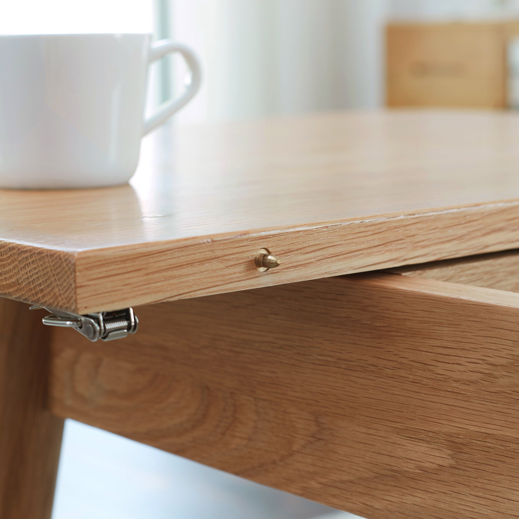 Wooden table with a white cup on a blurred background