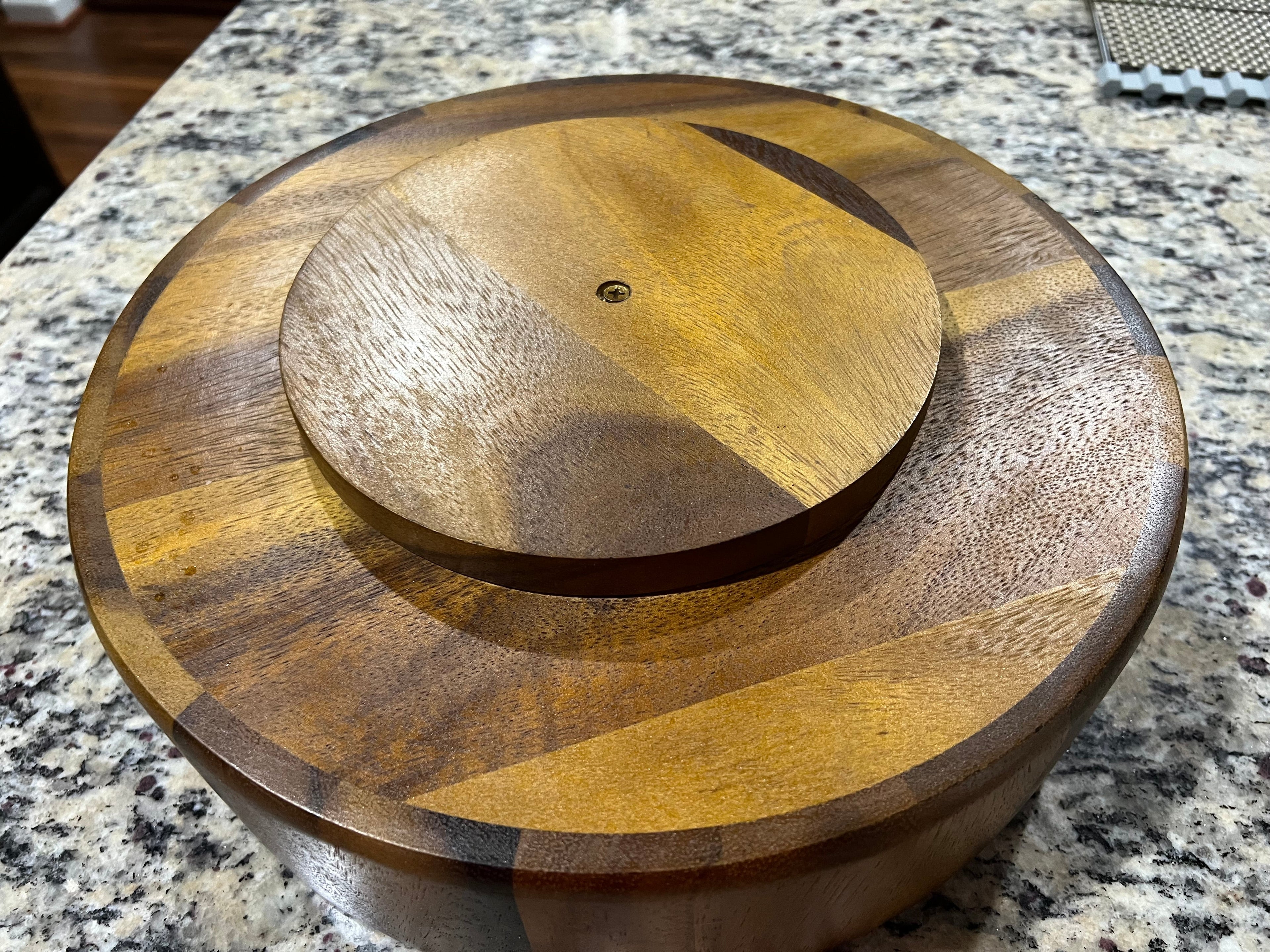 Wooden turntable with concentric circles on a granite countertop