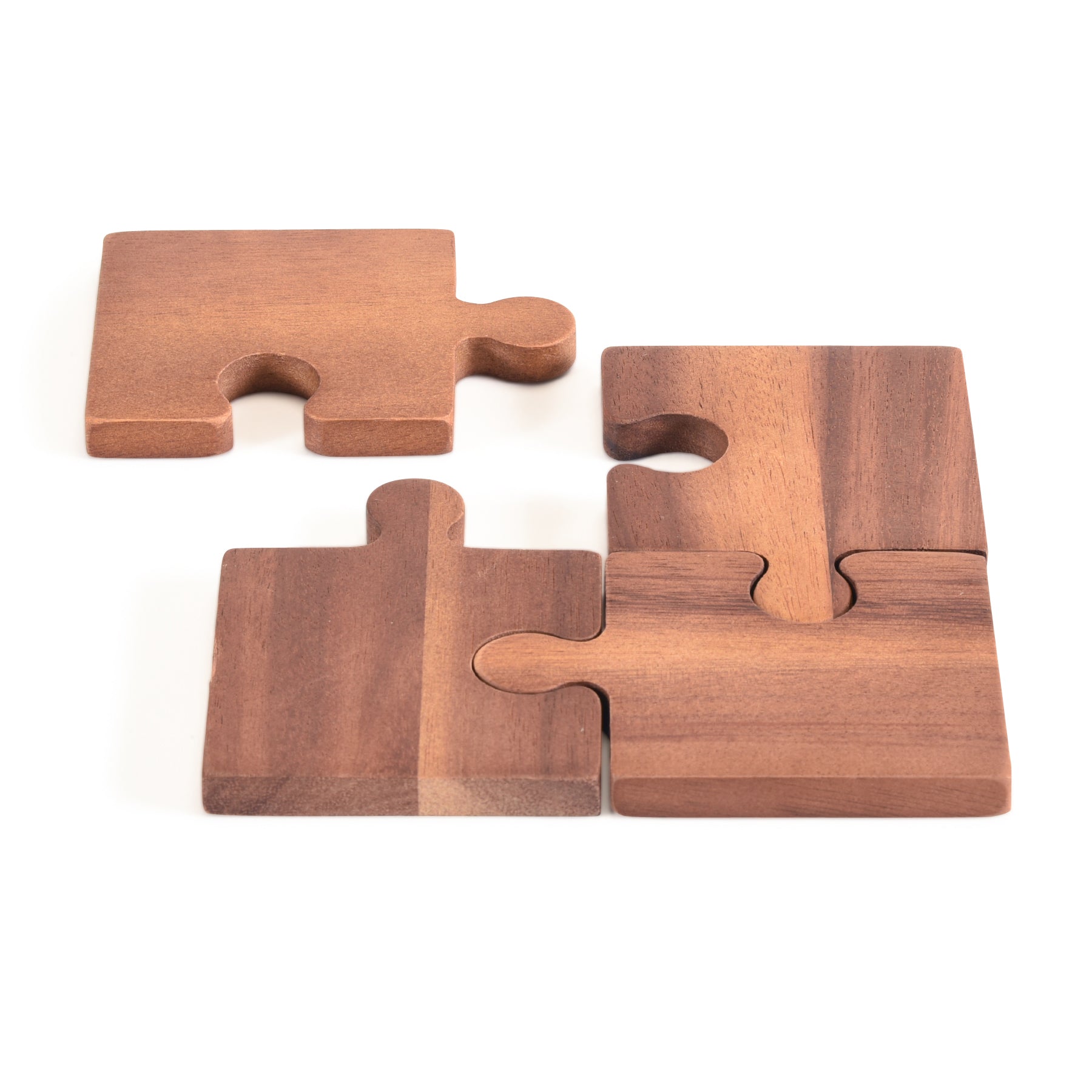 Four wooden puzzle pieces on a white background