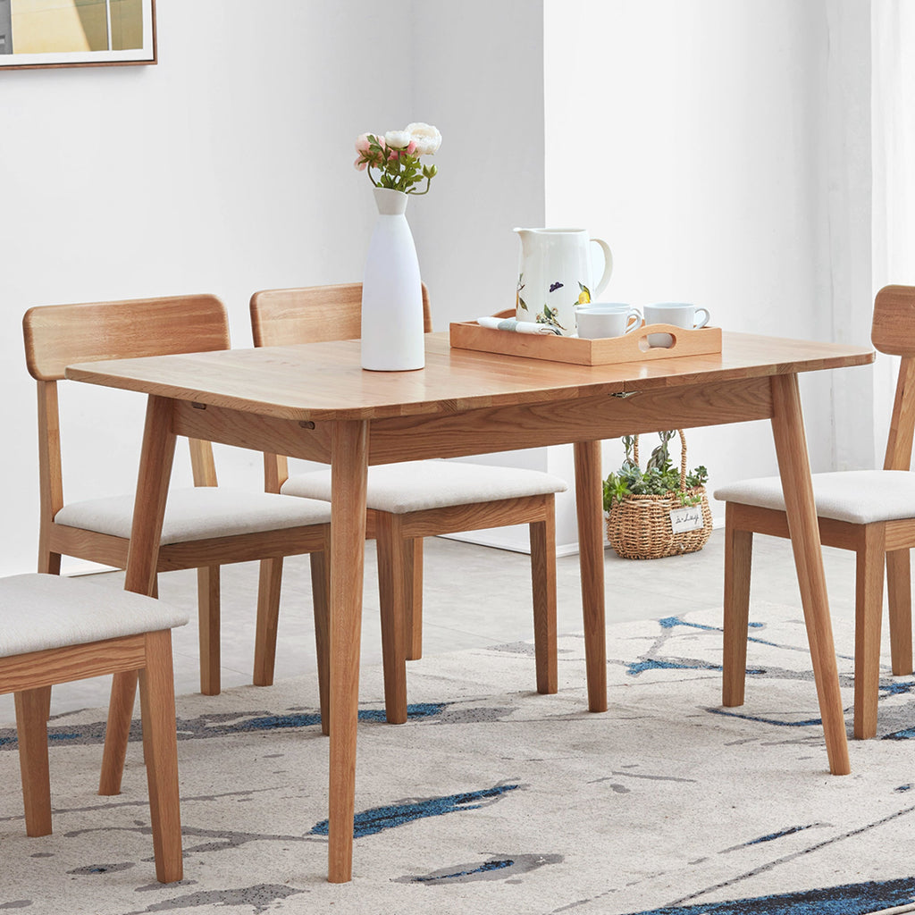 Dining room with wooden table and chairs on a patterned rug