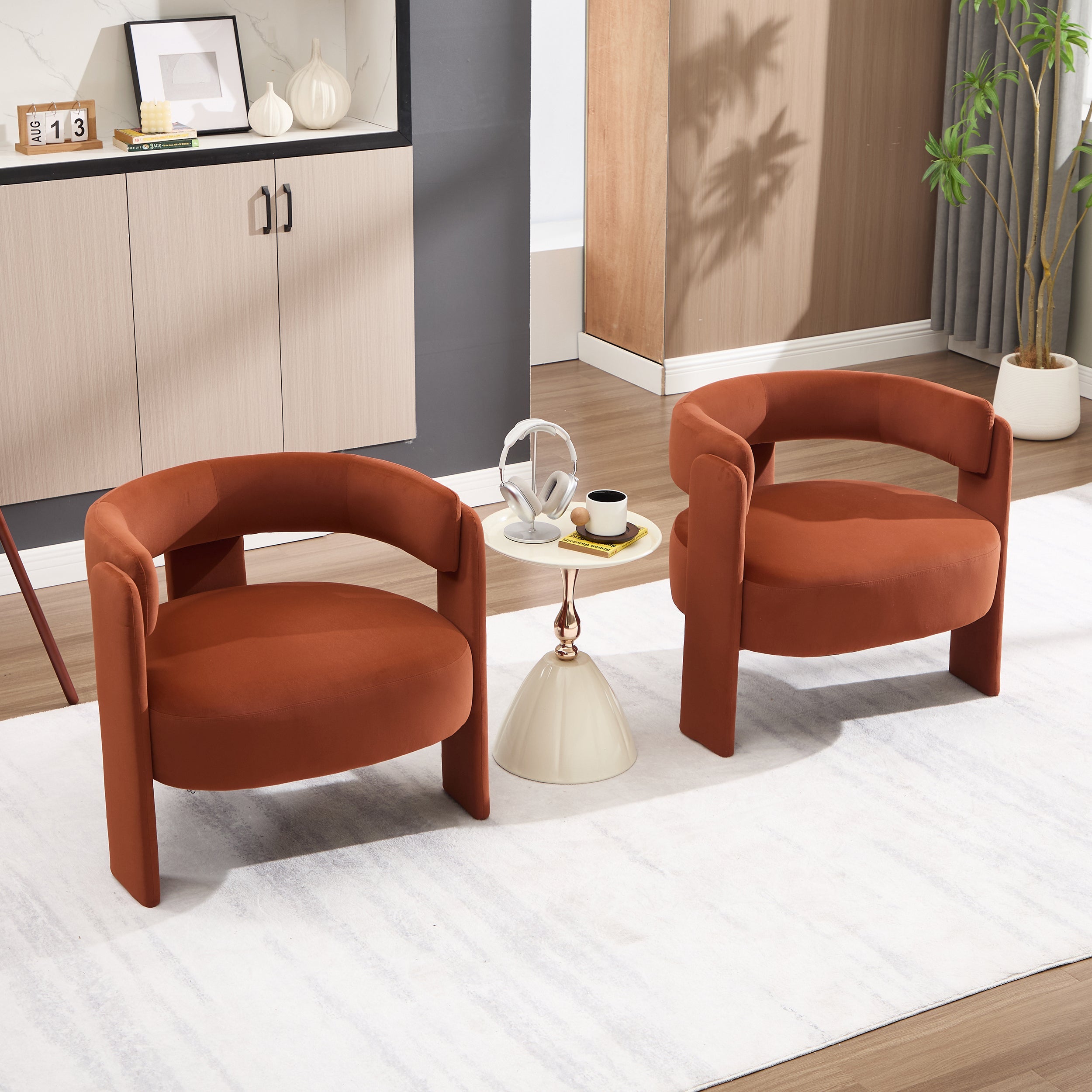 Two brown armchairs in a living room setting with a small table and decor items.