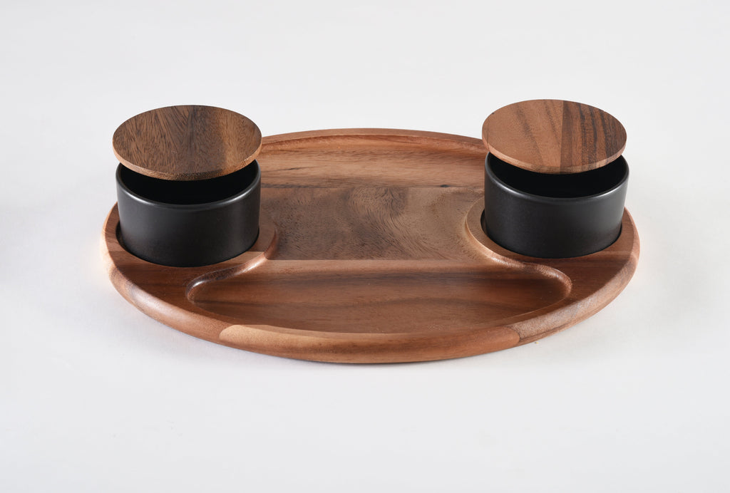 Wooden tray with two black containers on a white background