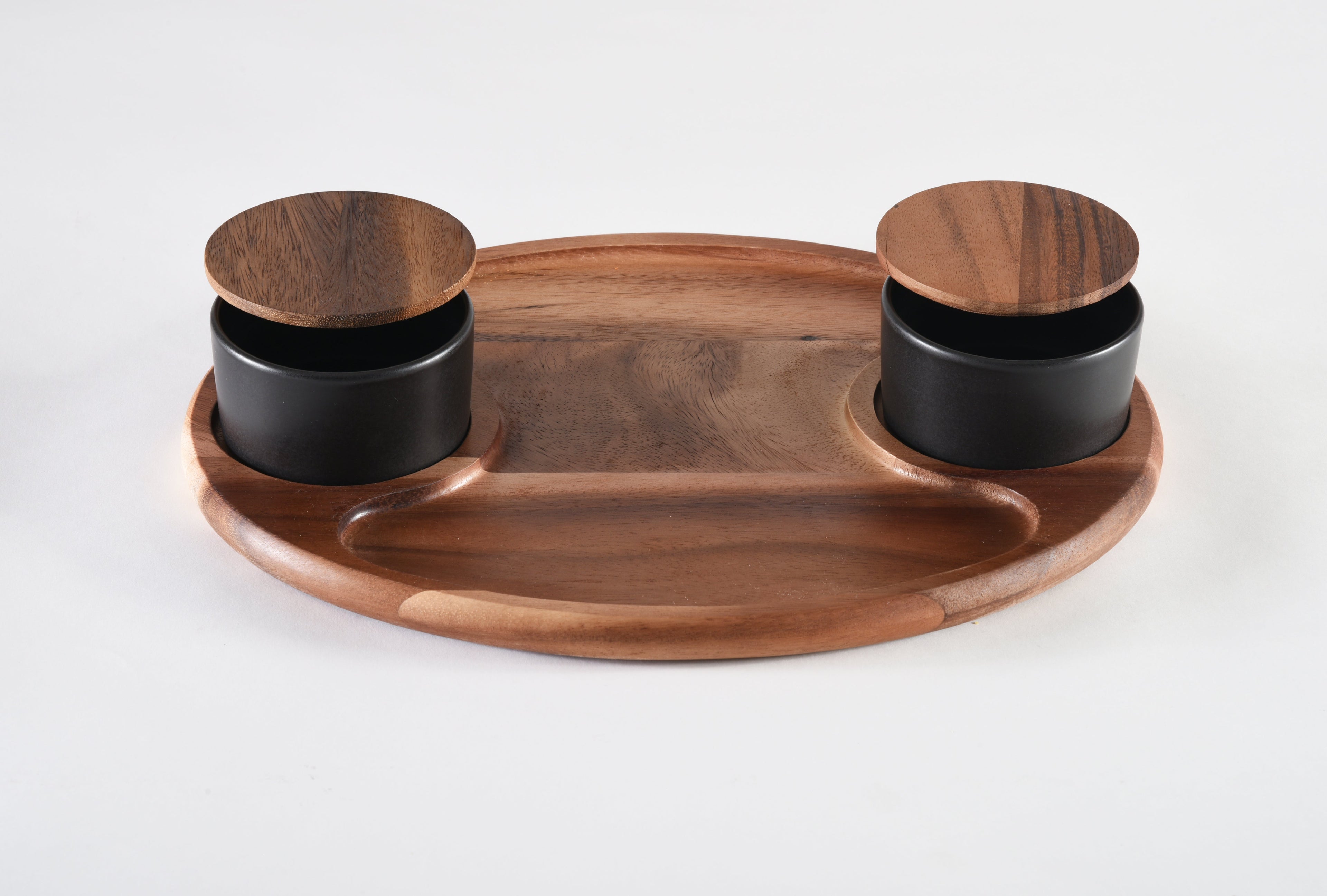 Wooden tray with two black containers on a white background