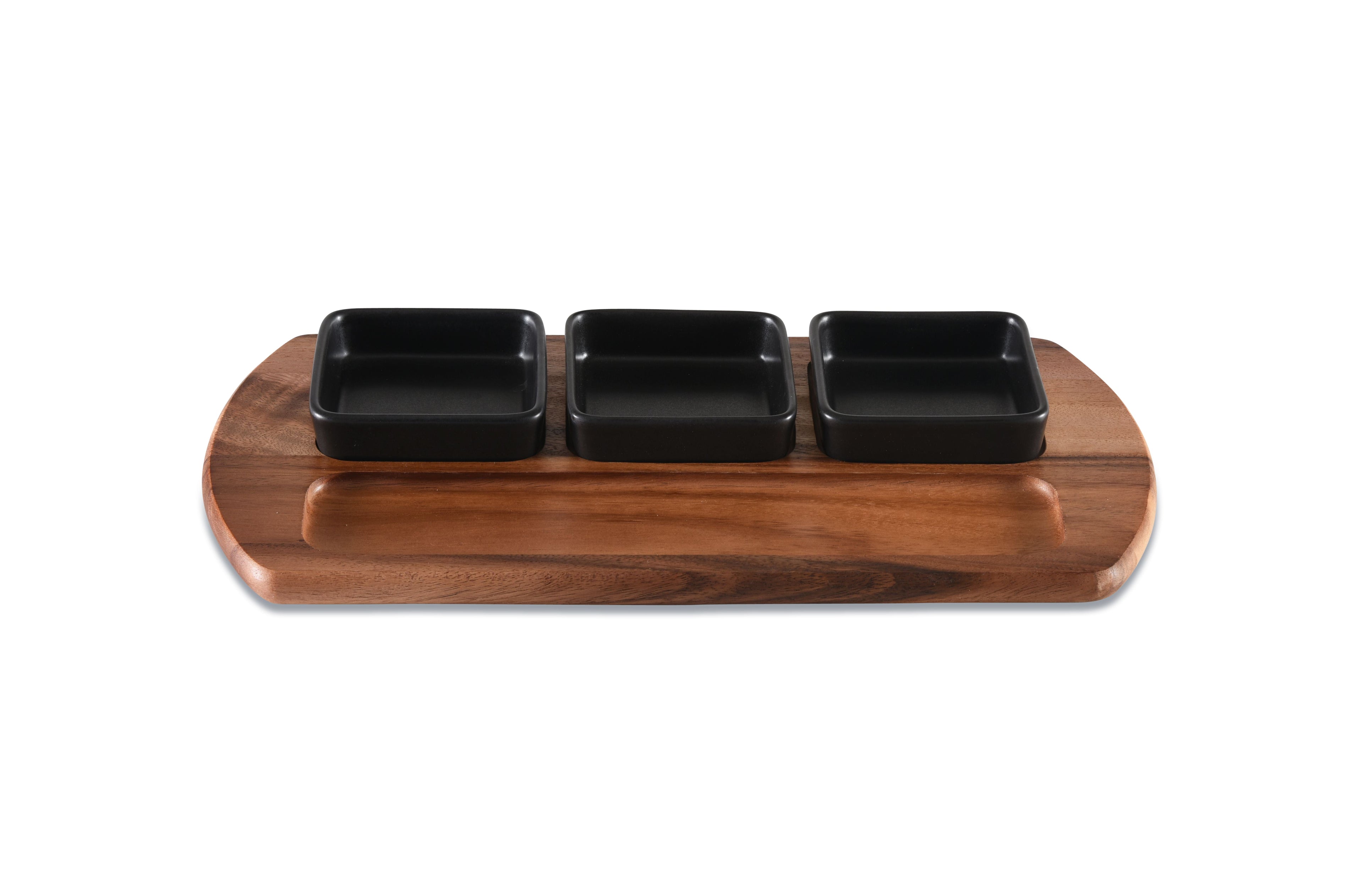 Wooden tray with three black square dishes on a white background