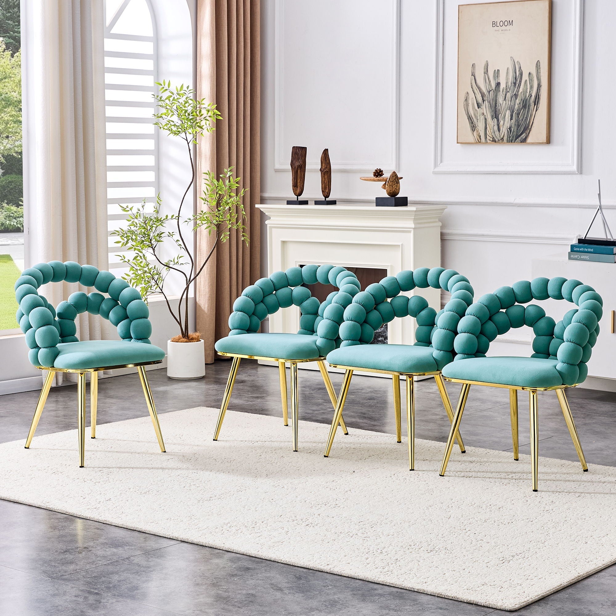 Set of four teal chairs with gold legs in a living room setting.
