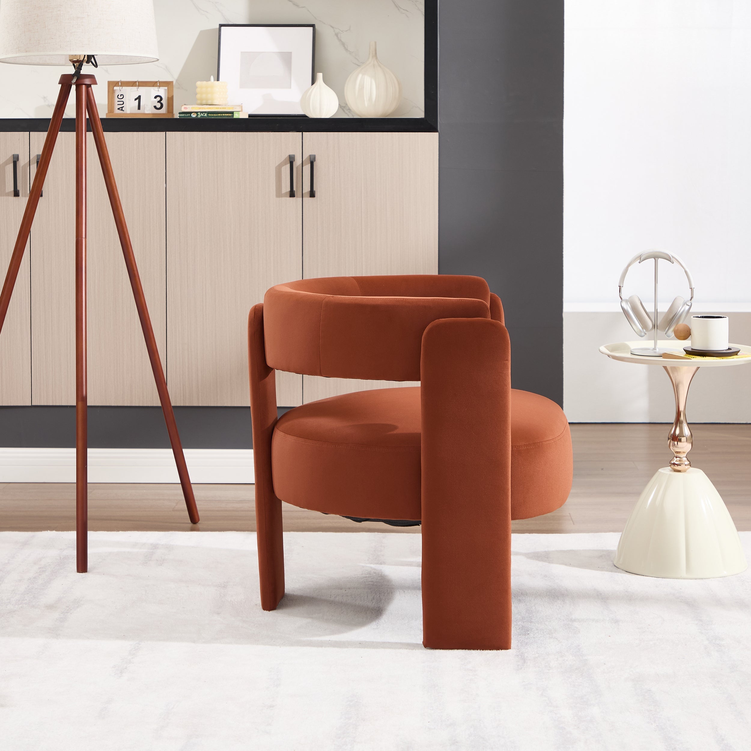 Modern orange chair in a stylish room with decor elements.