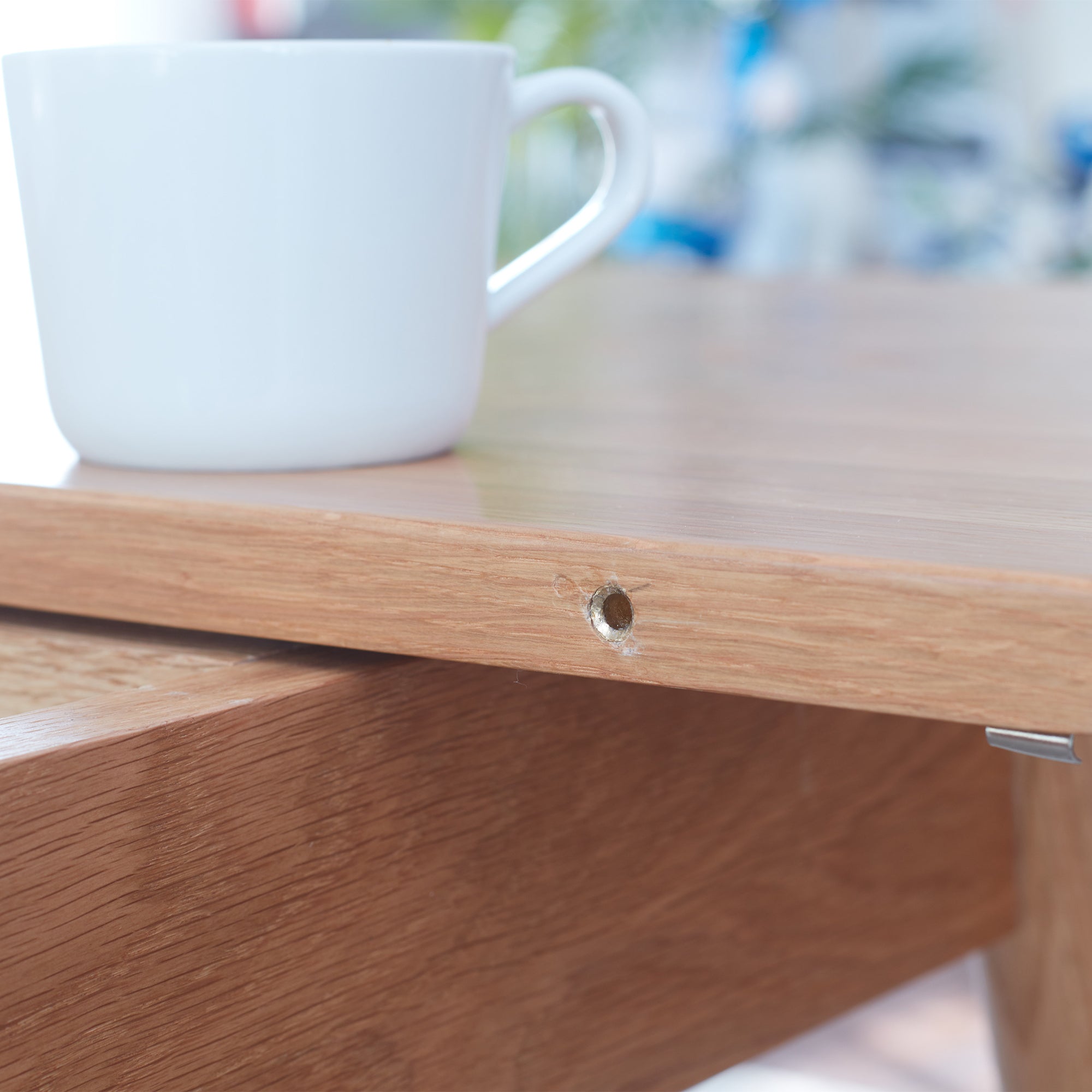 White mug on a wooden table with a blurred background