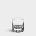 Clear glass tumbler on a light gray background