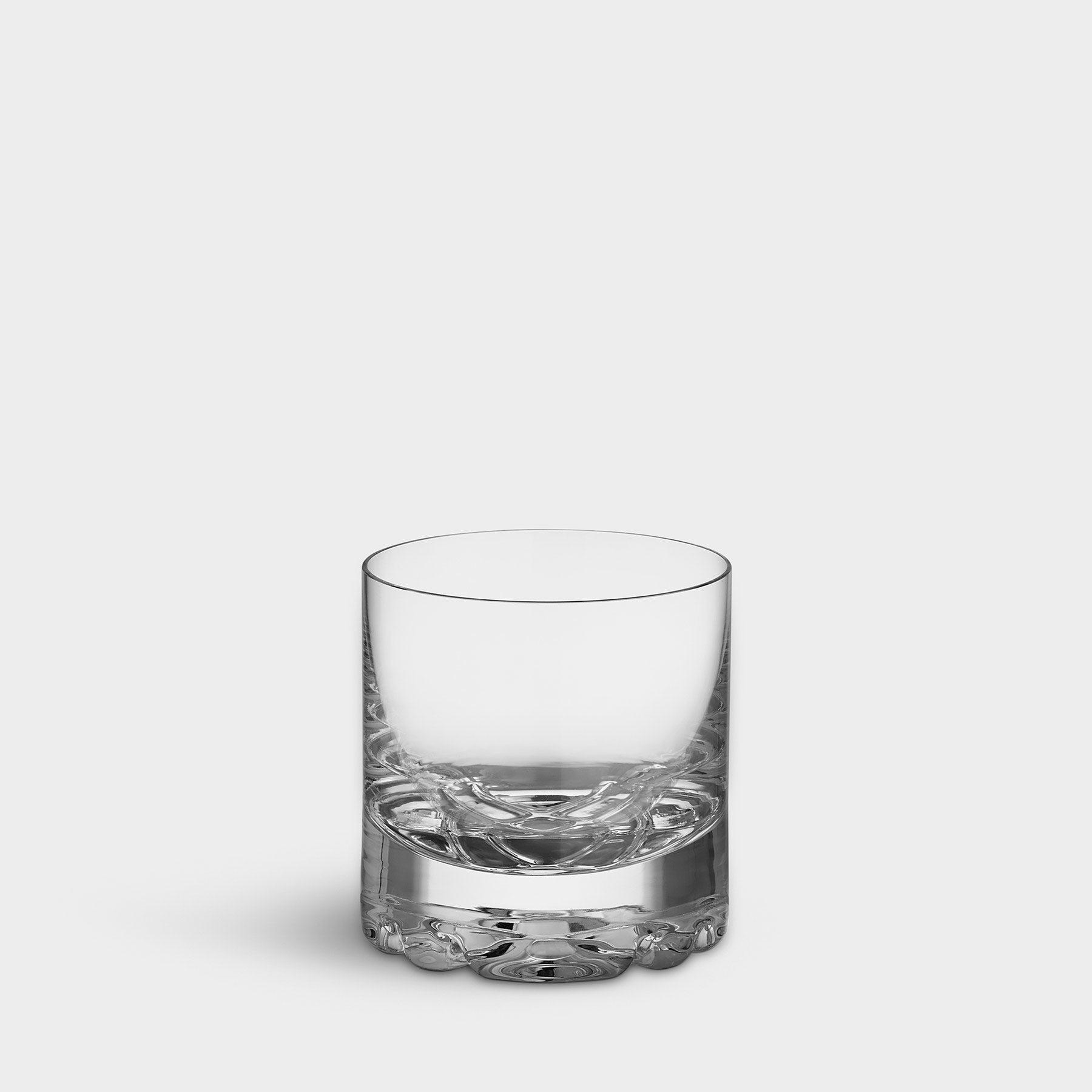 Clear glass tumbler on a light gray background