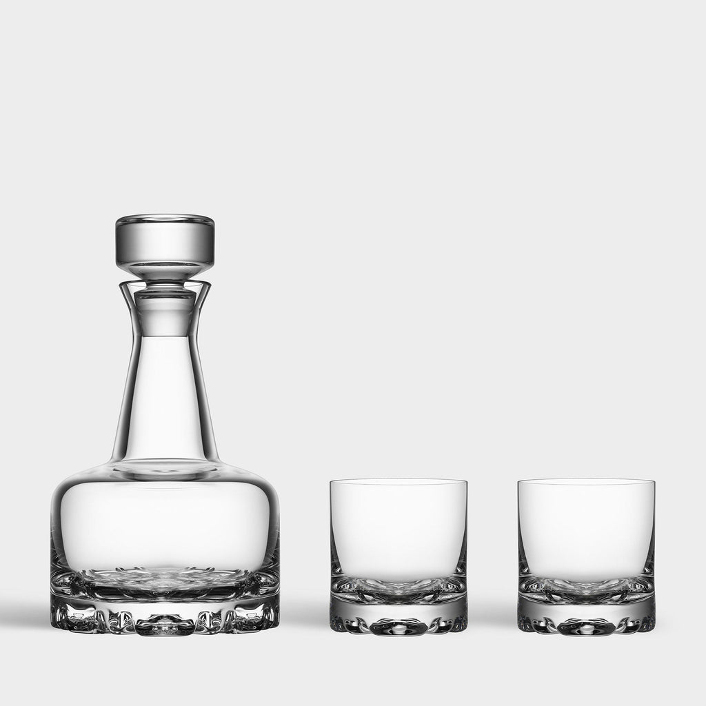 Clear glass decanter and two glasses on a white background