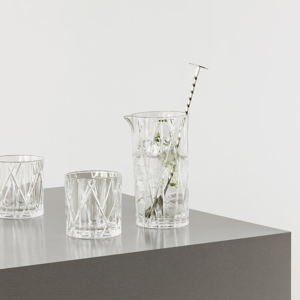 Set of crystal glasses on a gray surface with a white background