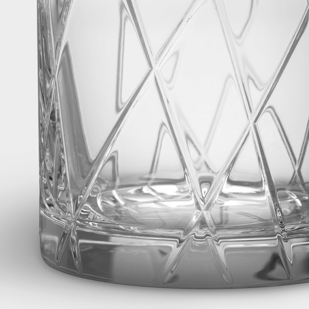 Close-up of a crystal glass with geometric patterns on a white background