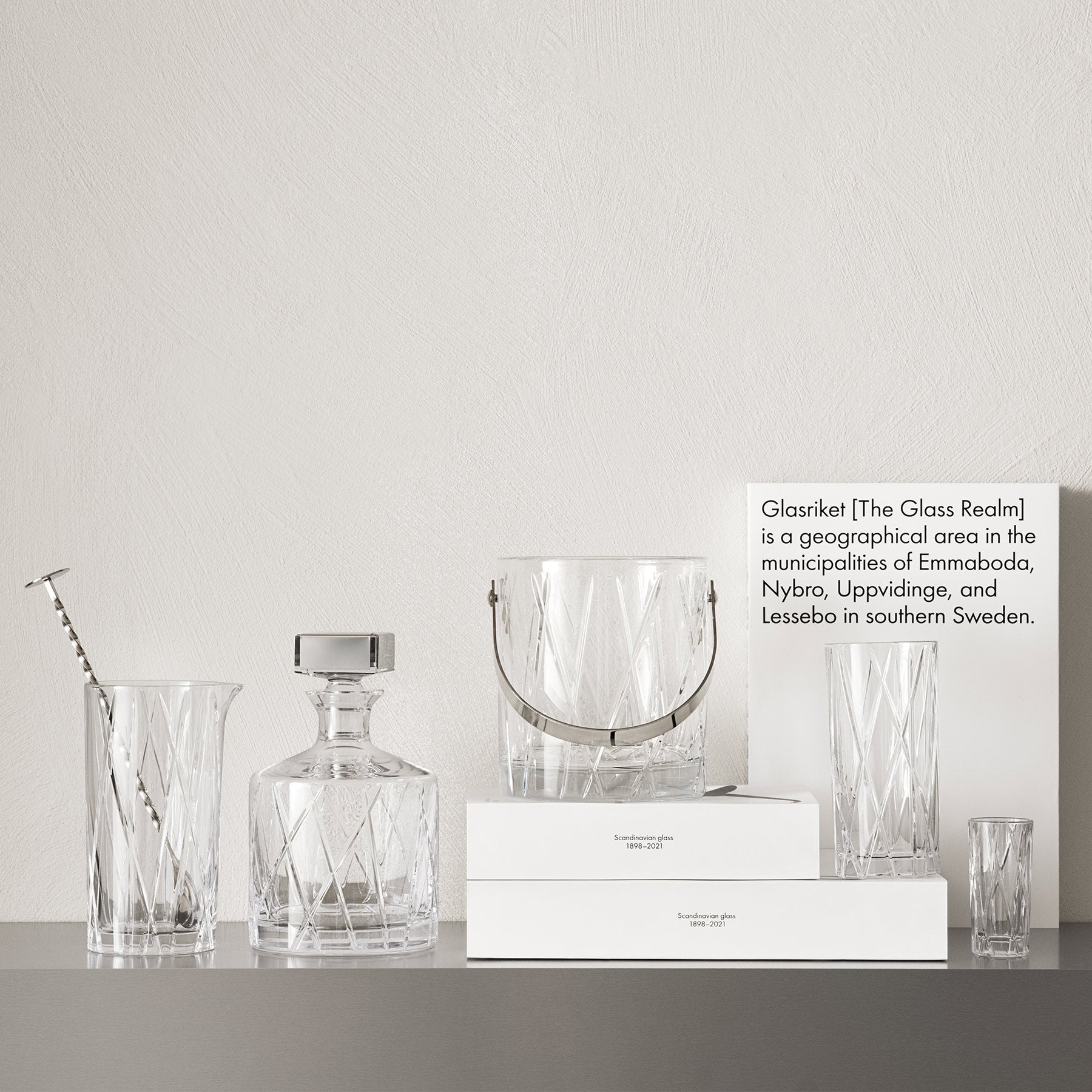 Clear glassware and crystal products on a gray surface with a white background
