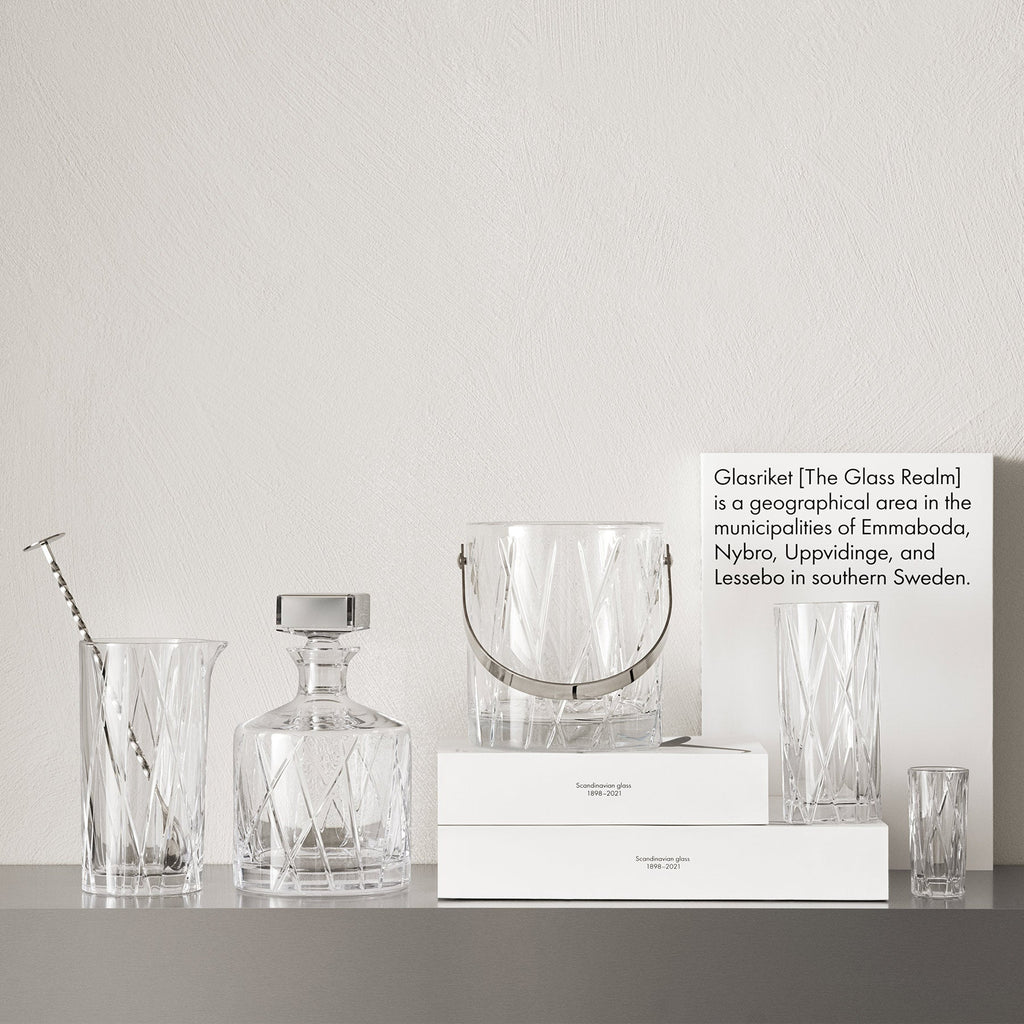 Clear glassware and crystal products on a gray surface with a white background