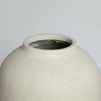 Beige ceramic vase on a light gray background