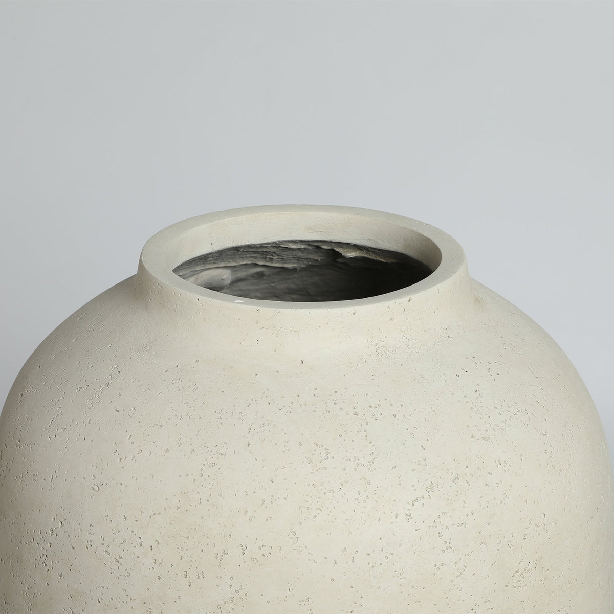 Beige ceramic vase on a light gray background