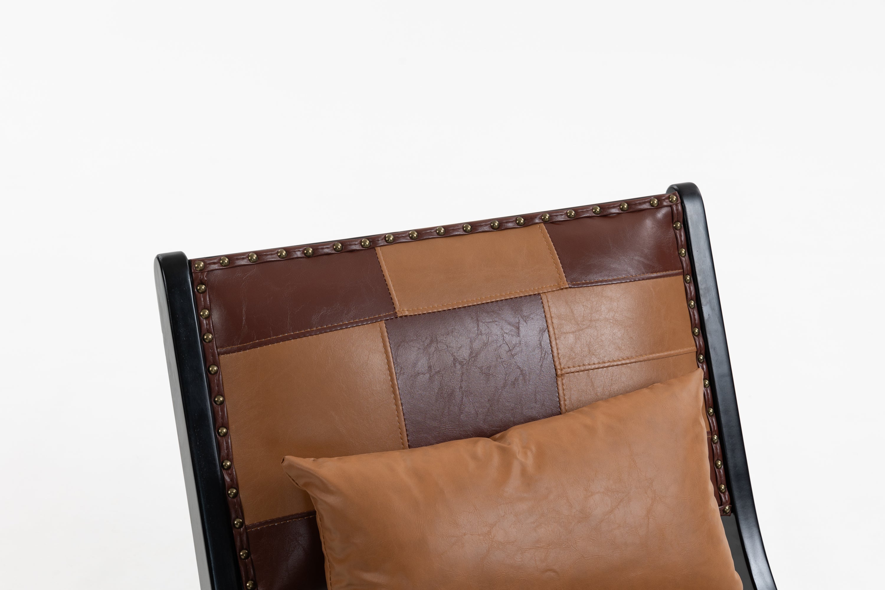 Brown leather patchwork chair with a pillow on a white background