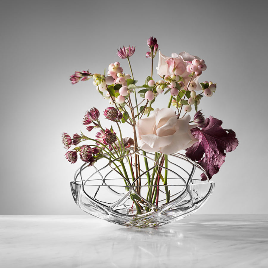 Clear glass vase with a bouquet of flowers on a white background