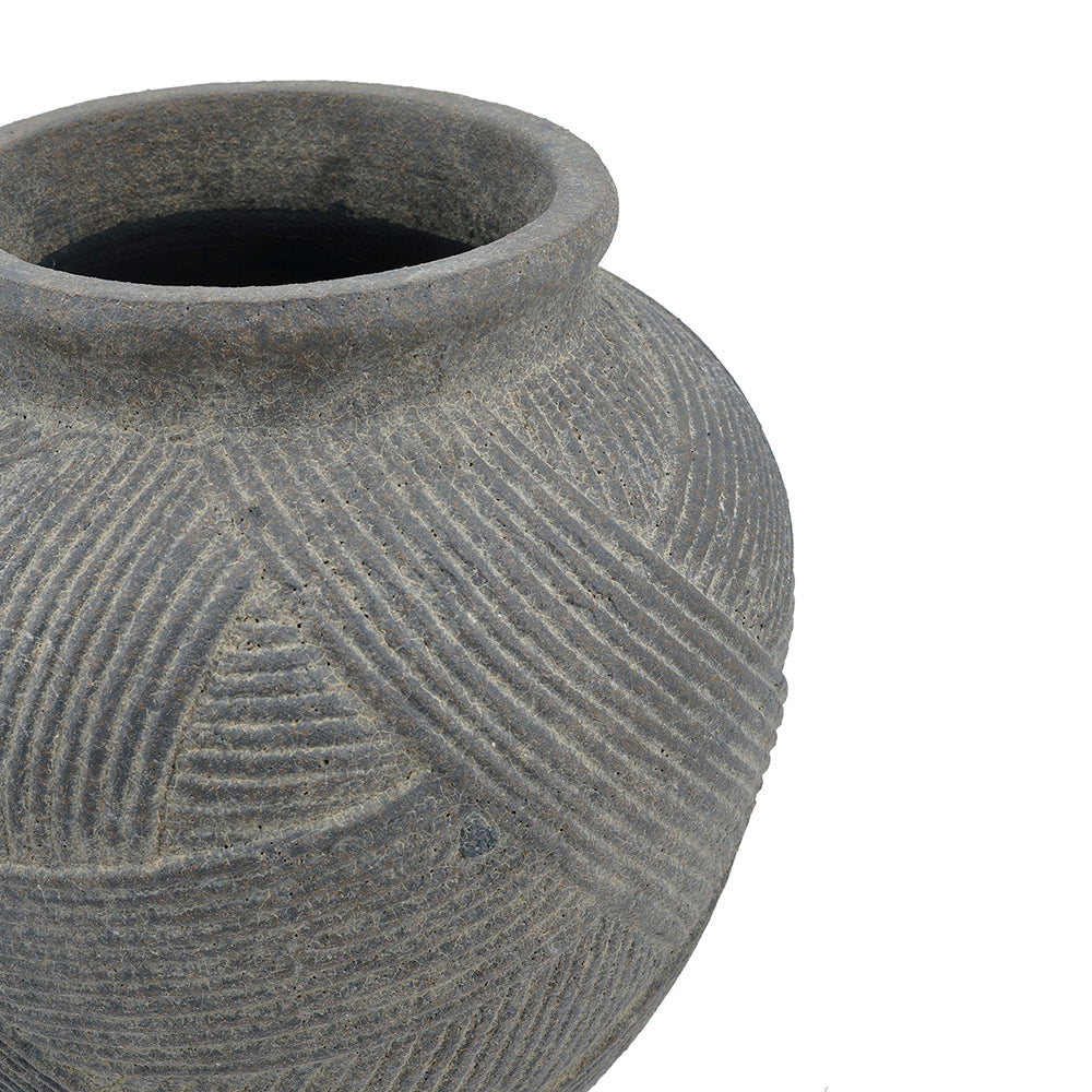 Close-up of a textured gray ceramic pot with carved geometric patterns, shown against a plain white background.