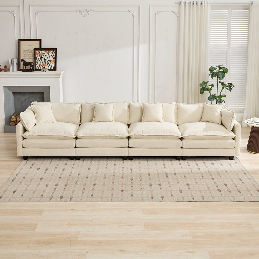 Beige 4-seater sofa in a living room with a fireplace and decor.