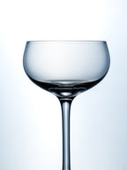 Clear glass wine glass on a light blue background