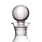Clear glass decanter with a spherical glass stopper, shown on a plain white background.
