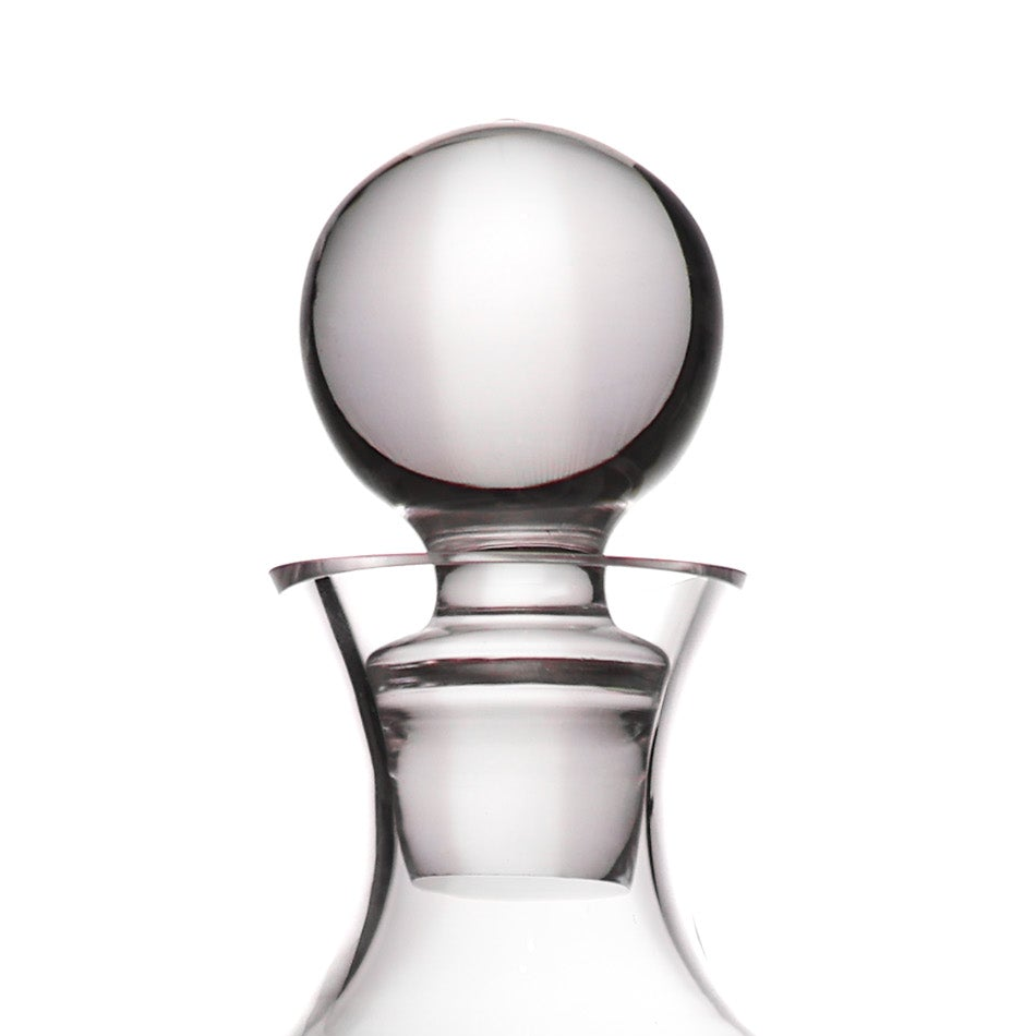 Clear glass decanter with a spherical glass stopper, shown on a plain white background.