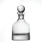 Clear glass decanter with honeycomb pattern and a spherical stopper on a white background