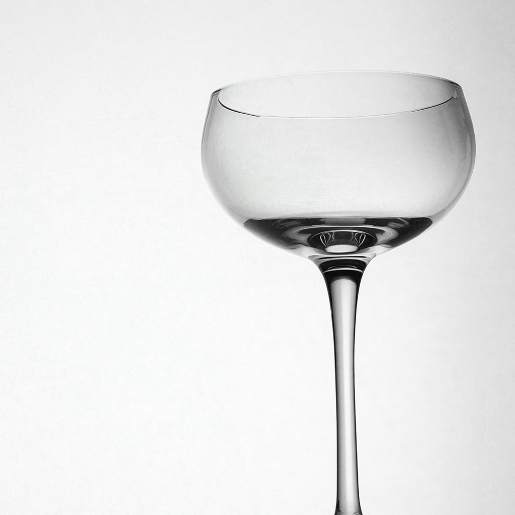 Clear glass cocktail glass on a white background
