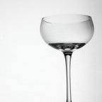 Clear glass cocktail glass on a white background