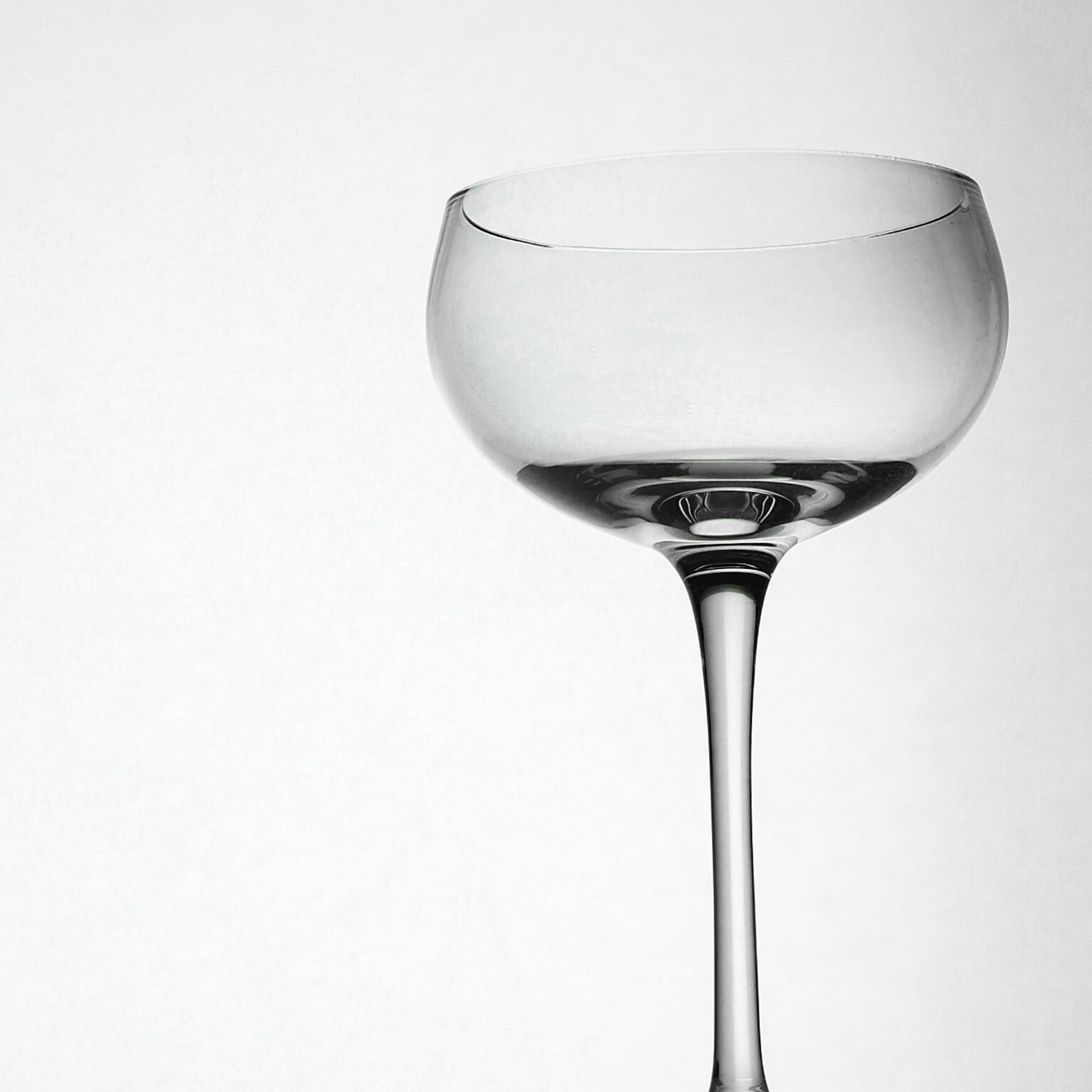 Clear glass cocktail glass on a white background