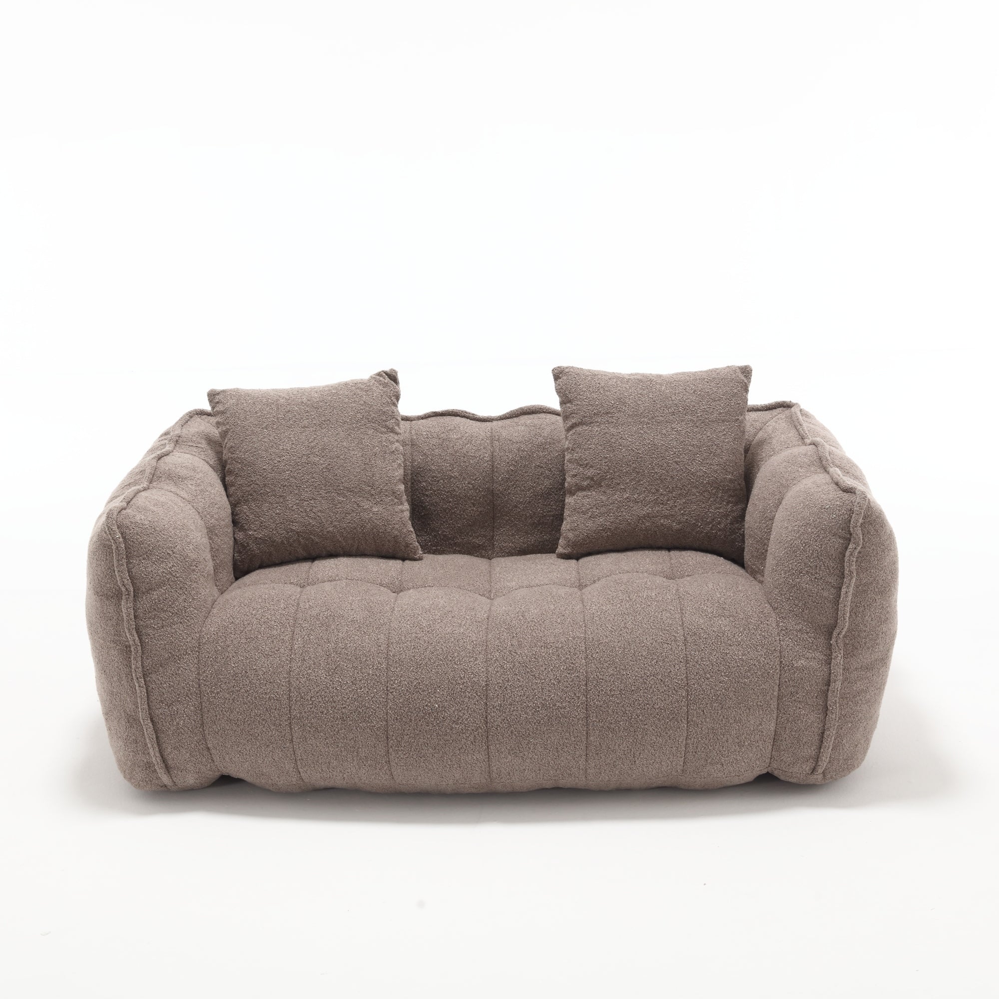 Brown sofa with quilted design and two cushions on a white background