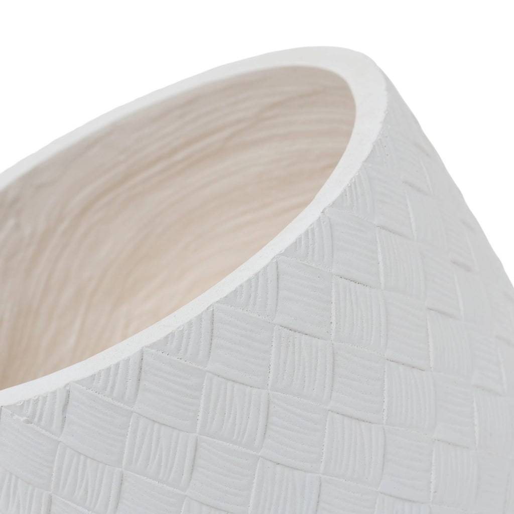 Close-up of a white planter with a textured basketweave pattern and a light beige interior, shown on a white background.