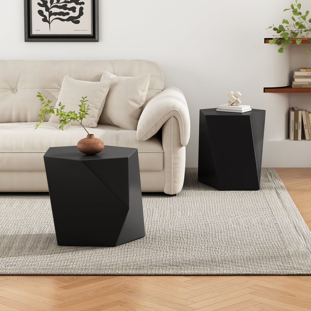 Modern living room with a beige sofa, black side tables, and decorative elements.