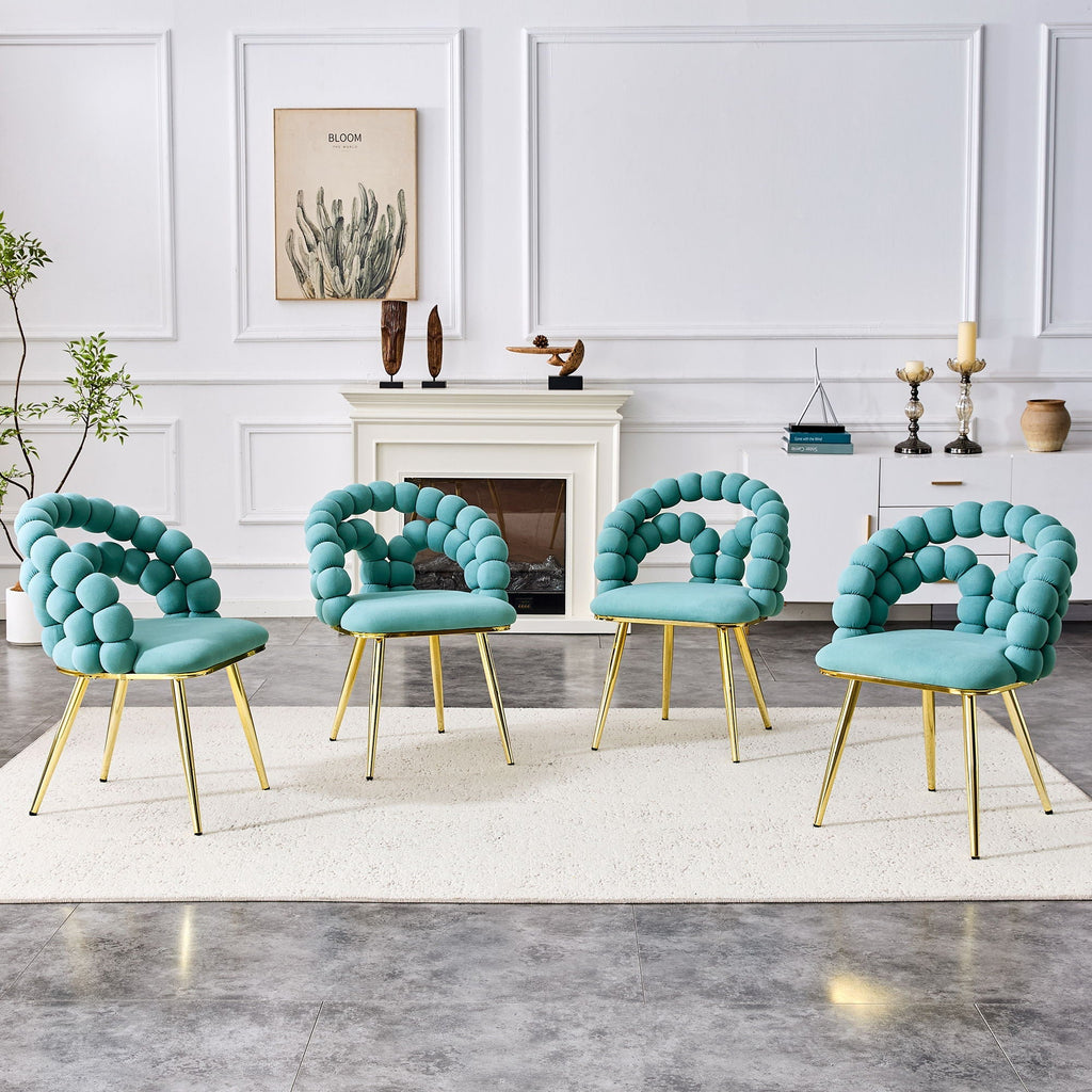 Four turquoise chairs with gold legs arranged in a living room setting.