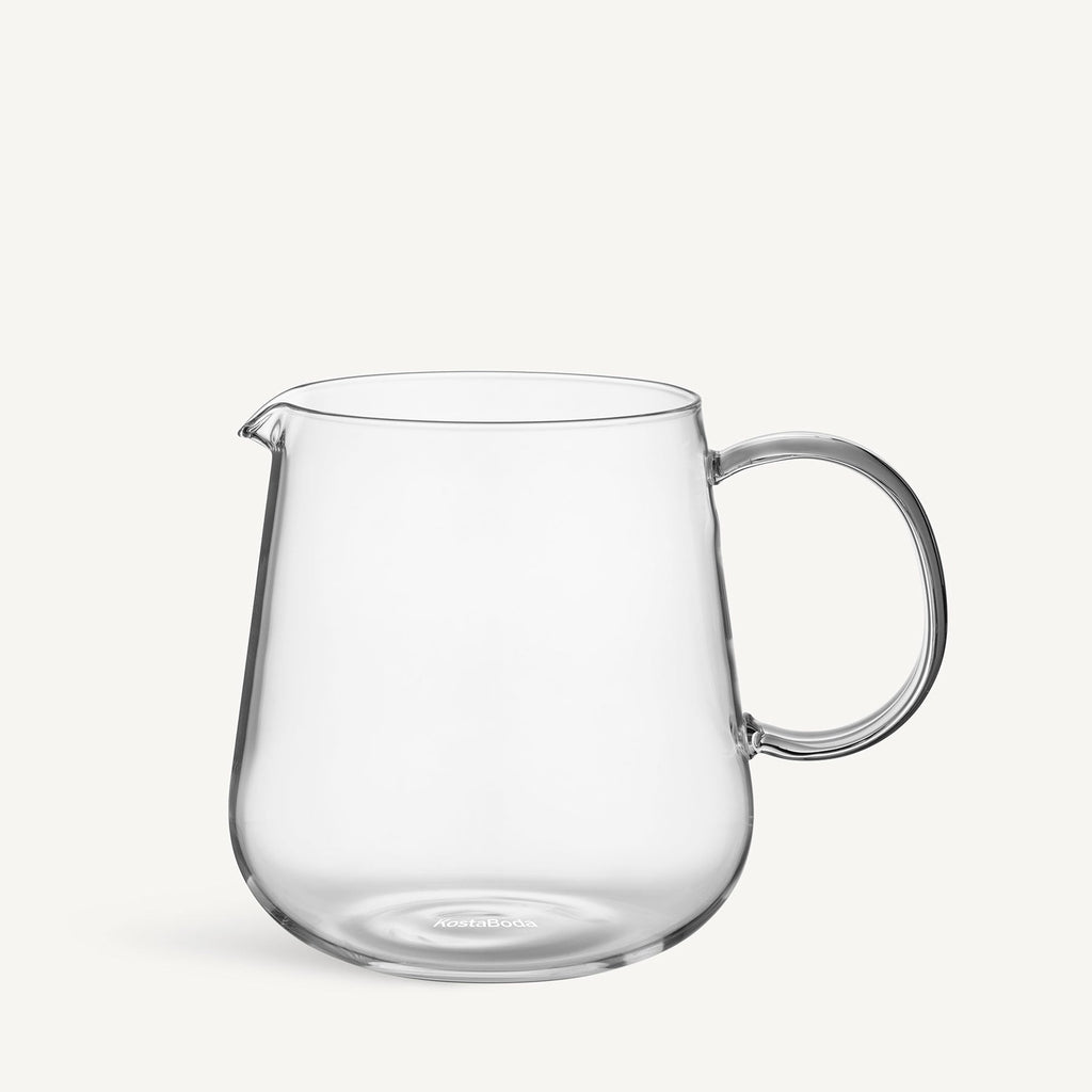 Clear glass pitcher on a white background
